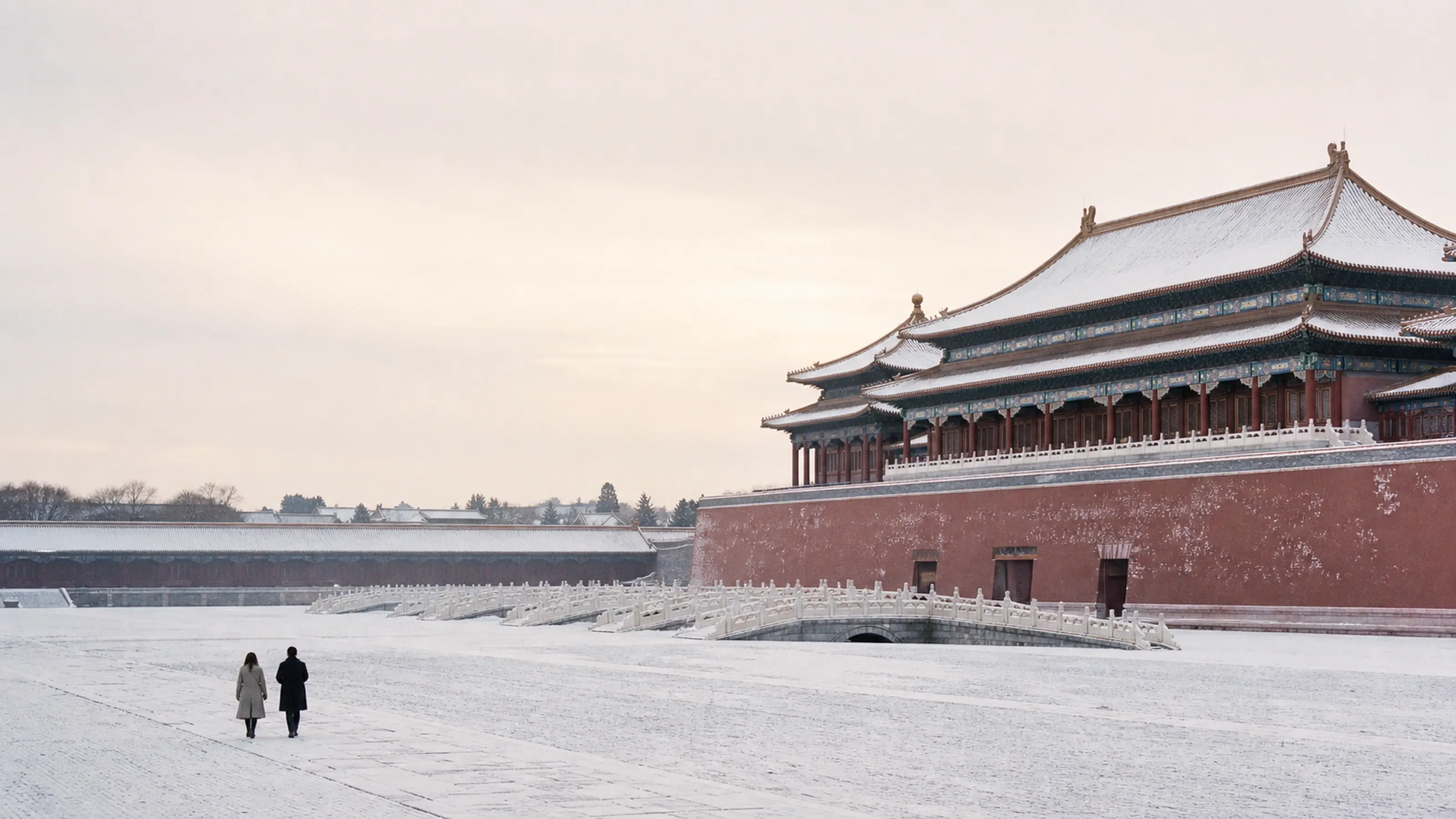 Snow settling on the golden roofs and red walls of the Forbidden City
