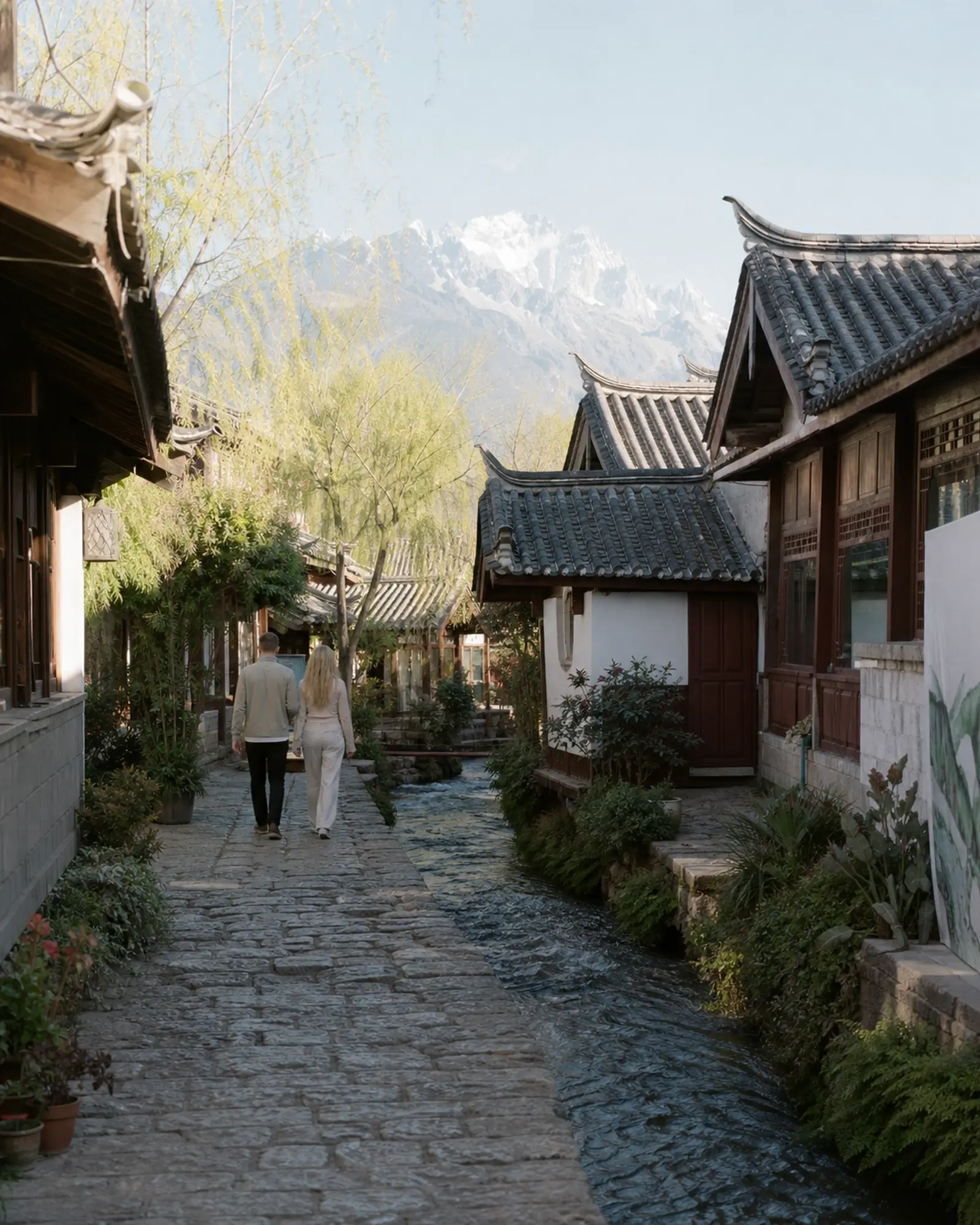 Grey-tiled Naxi houses along a canal in Lijiang Old Town